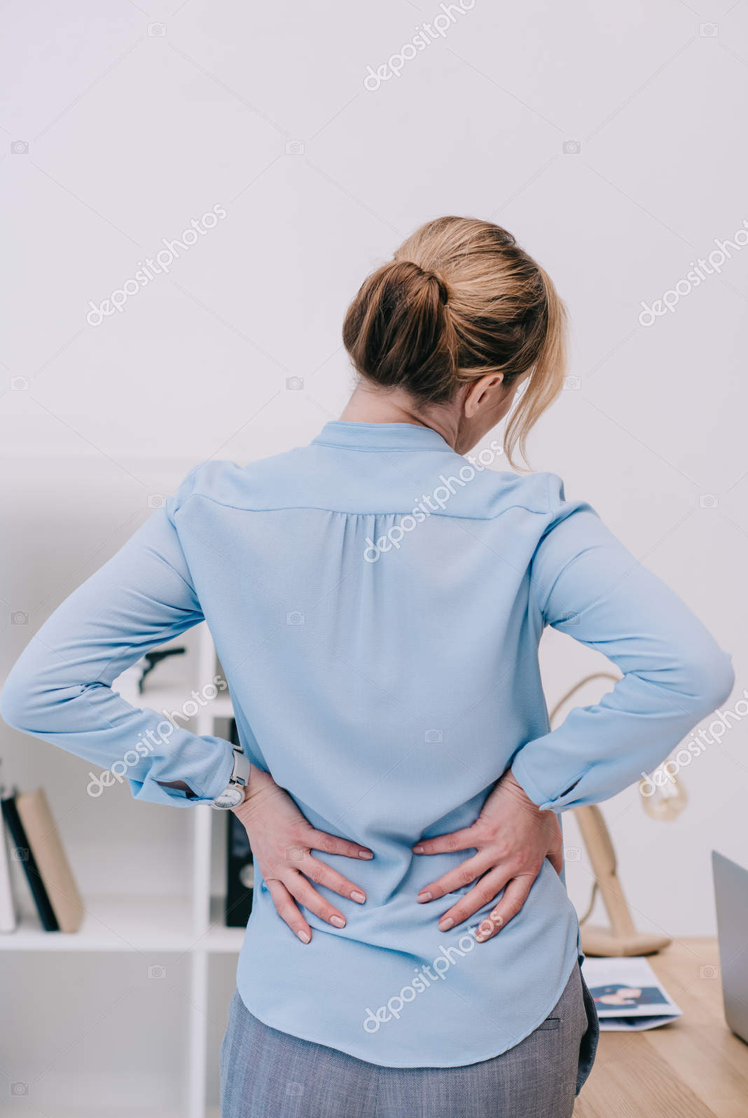 depositphotos_182638430-stock-photo-rear-view-overworked-businesswoman-backpain